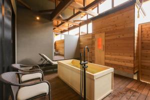 a bathroom with a sink and chairs in it at Hotel 4CROWNS-ブラックプラン in Katsuyama