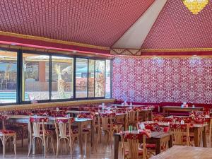 a restaurant with tables and chairs in a room at Golde bubble camp in Wadi Rum