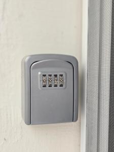 a electrical outlet on a wall with a curtain at Dimi Deluxe in Perea