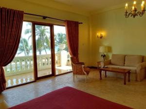 a living room with a couch and a large window at Samsara in Galle