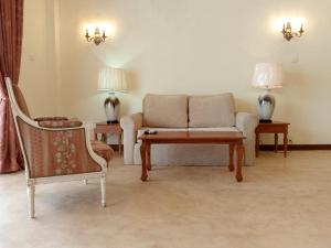 a living room with a couch and a table and chairs at Samsara in Galle