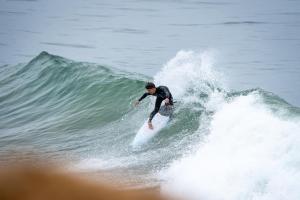 a man riding a wave on a surfboard in the ocean at Westpoint Dakhla in Dakhla
