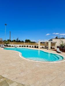 a swimming pool with blue water in a patio at Lux apartments in Porto Cesareo