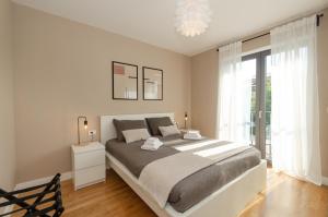 a bedroom with a large bed and a large window at Green view apartment in Rovinj