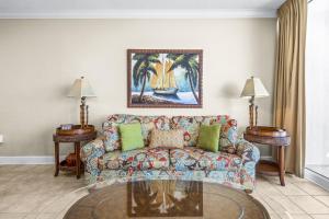 a living room with a couch and two tables at San Carlos Condos in Gulf Shores +257 photos