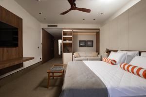 a bedroom with a large bed with a ceiling fan at Infinity Hotel & More in Budva