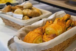 two baskets filled with pastries on a table at Art Hotel William in Bratislava