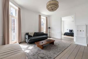 a living room with a couch and a table at Chic Apartment in Vibrant Area by Copenhagen Canals in Copenhagen