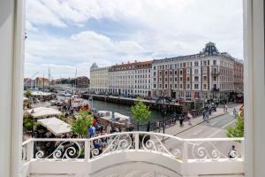 a balcony with a view of a harbor and buildings at Chic Apartment in Vibrant Area by Copenhagen Canals in Copenhagen