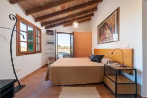 a bedroom with a large bed and a table at Sa Teulera de Pina in Pina +51 photos