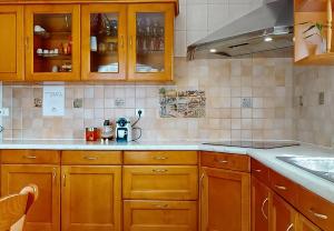 a kitchen with wooden cabinets and a sink at Stunning House 5-Bedrooms for 9P- 20min from Paris in Le Blanc-Mesnil +41 photos