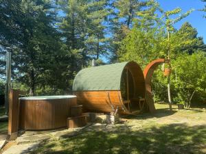 a large wooden hobbit house in a park at Chalet Bosco Magico Roccolo in CastellʼArquato