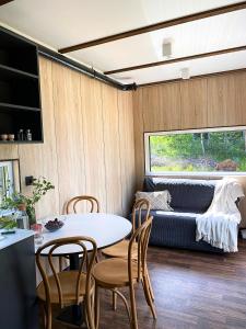 a living room with a table and chairs and a couch at Arche Siedlisko Miedwieżyki in Milejczyce +11 photos