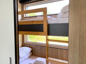 a bunk bed in a small room with a window at Arche Siedlisko Miedwieżyki in Milejczyce