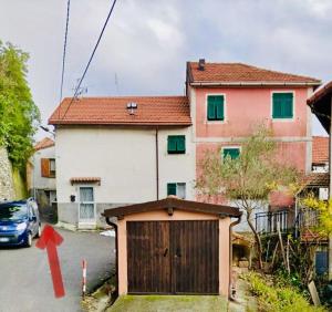 a house with a garage in front of it at Casa Voje in Serra Rocco