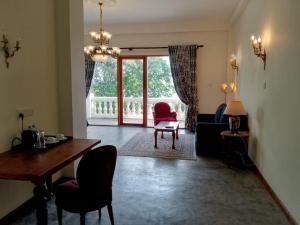 a living room with a table and chairs and a dining room at Samsara in Galle