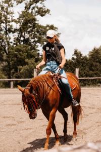 a woman riding on the back of a horse at BUBLA CITY RANCH in Kopřivnice
