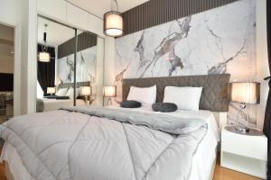a bedroom with a large bed with two pillows on it at Luxury one bedroom apartment in beachfront apart Hotel in Budva