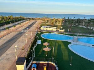 an overhead view of a resort with a swimming pool and the ocean at MAGIC WORLD Vacaciones in Castellón de la Plana