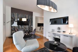 a living room with a table and chairs at Luxury one bedroom apartment in beachfront apart Hotel in Budva