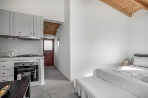 a bedroom with a bed and a table and a fireplace at Angel’s studio in Potamós