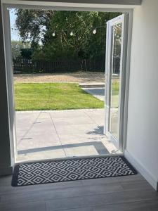 an open door of a house with a yard at The Old Stable, Rustic Charm Modern Comforts in Gorfield