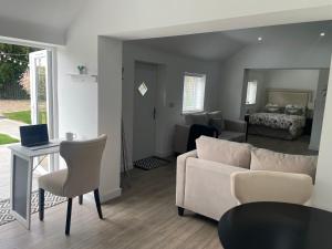 a living room with a couch and a table at The Old Stable, Rustic Charm Modern Comforts in Gorfield