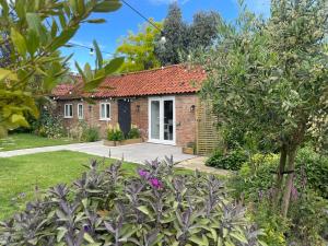 a brick house with a red roof at The Old Stable, Rustic Charm Modern Comforts in Gorfield