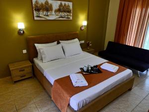 a hotel room with a bed with a tray on it at Mente Libre Villas in Nea Plagia