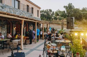 a crowd of people sitting at tables outside a building at Domaine Santa Margherita in Castellare-di-Casinca