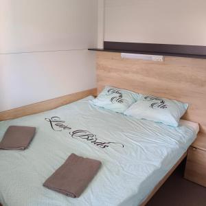 a bed with two pillows on it in a room at Camping Planik in Ražanac