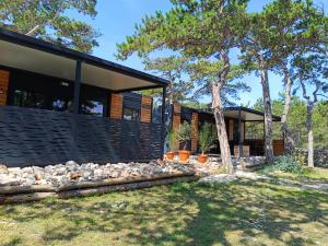 a modern house with a black facade at Camping Planik in Ražanac