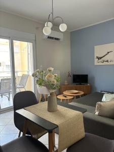 a living room with a couch and a table at Blooming 31 AXD in Alexandroupoli
