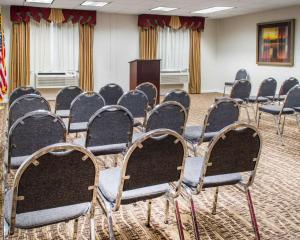 a row of chairs in a room with a podium at Quality Suites Waldorf in Waldorf