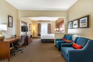 a hotel room with a bed and a desk at Comfort Suites - Jefferson City in Jefferson City