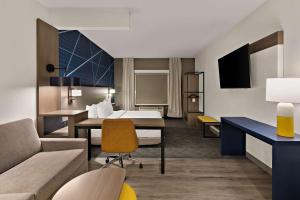 a hotel room with a bed and a desk at Comfort Suites Columbus East Broad in Columbus +71 photos