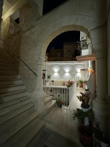 an archway with stairs in a building at night at Onny's House in Bari