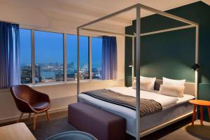 A bed or beds in a room at Comwell Aarhus Dolce by Wyndham