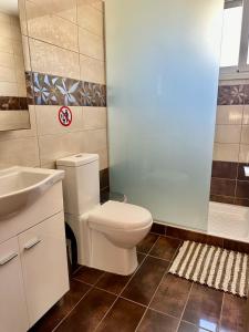 a bathroom with a toilet and a sink at Michael Angelo Luxuri Villa 4 bedroom in Paphos +37 photos