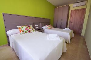 Postel nebo postele na pokoji v ubytování Hotel Primavera