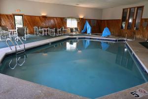 a large swimming pool with chairs and a table at Country Inn & Suites by Radisson, Sparta, WI in Sparta