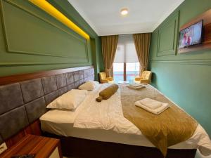 a bedroom with a bed with two towels on it at TRABZON Asel Suite Otel in Trabzon
