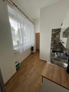 a kitchen with a sink and a counter top at Apartmán v Kyjově in Kyjov
