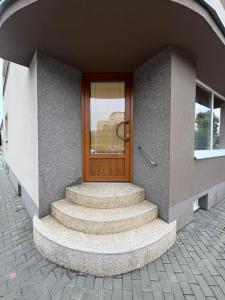 a front door of a building with a set of stairs at Apartmán v Kyjově in Kyjov
