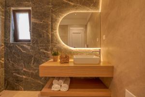 un bagno con lavandino e specchio di Edem Stone Villa a Kíssamos Altre 82 foto