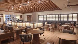 a restaurant with tables and chairs and a bar at Hanok Hotel DAAM Seoul in Seoul