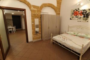Ένα ή περισσότερα κρεβάτια σε δωμάτιο στο Brindisi Antica