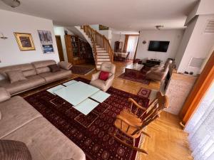 a living room with a couch and a table and chairs at Sarajevo Villa Ruza Vjetrova in Vinogradi