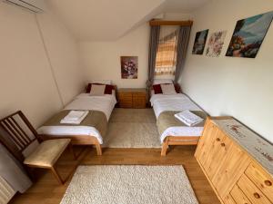 a room with three beds and a chair in it at Sarajevo Villa Ruza Vjetrova in Vinogradi