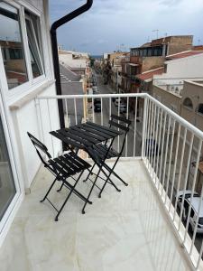 a balcony with chairs and a table on a balcony at Terrasini Sea in Terrasini